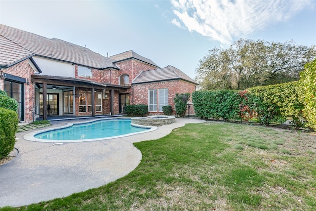 view of pool featuring a patio and a yard