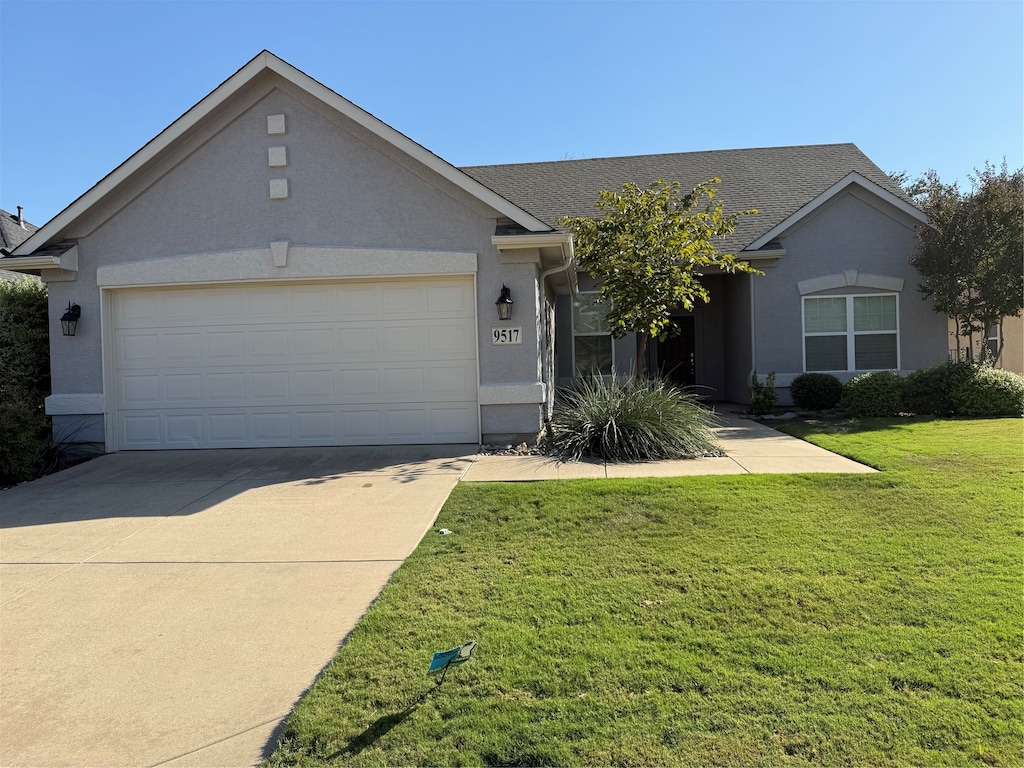 ranch-style house with a front yard and a garage