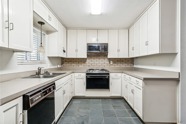 kitchen with white cabinetry, black appliances, sink, and pendant lighting