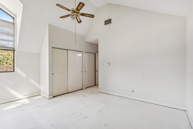 unfurnished bedroom with high vaulted ceiling and ceiling fan