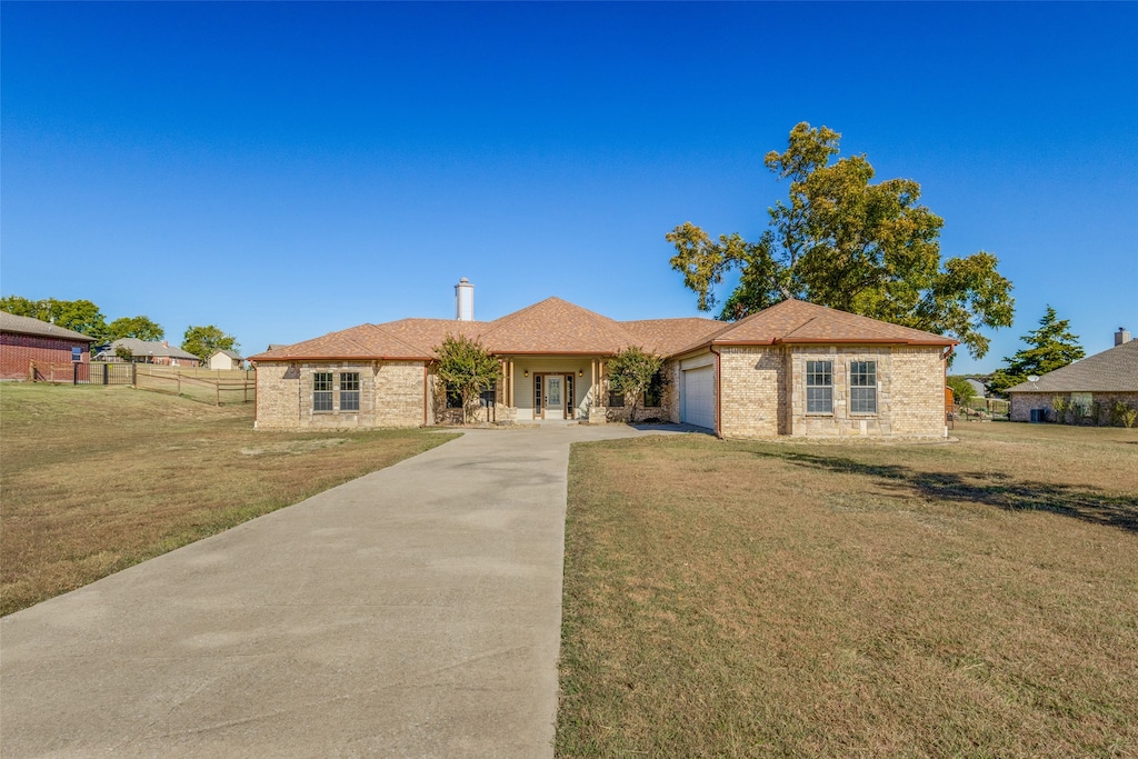 view of front of house with a front yard and a garage