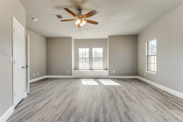 empty room featuring light hardwood / wood-style floors, plenty of natural light, and ceiling fan