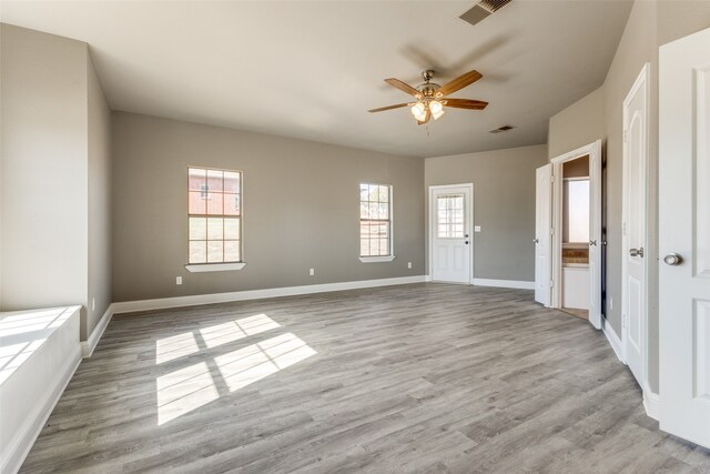 unfurnished room featuring light hardwood / wood-style floors, a wealth of natural light, and ceiling fan