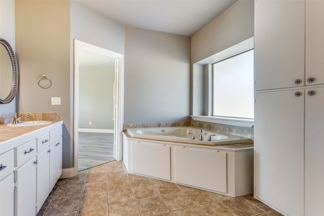 bathroom featuring vanity, tile patterned floors, and a washtub