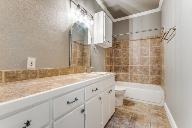 full bathroom featuring toilet, vanity, crown molding, tiled shower / bath combo, and tile patterned floors