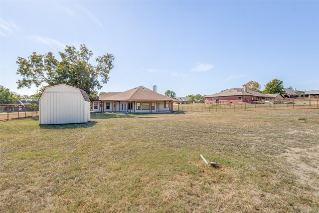 view of yard with a rural view and a storage unit