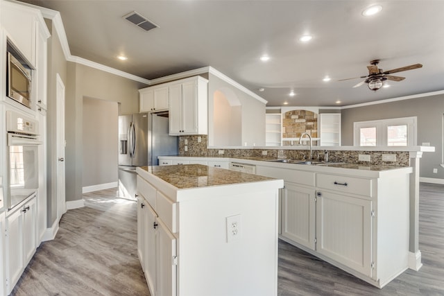 kitchen with a center island, light hardwood / wood-style flooring, and white cabinets