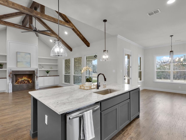 kitchen featuring sink, gray cabinets, a kitchen island with sink, decorative light fixtures, and stainless steel dishwasher