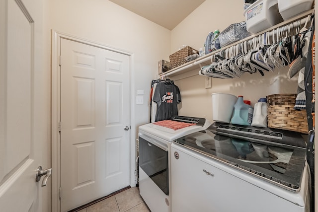 laundry area featuring washing machine and dryer and light tile patterned floors