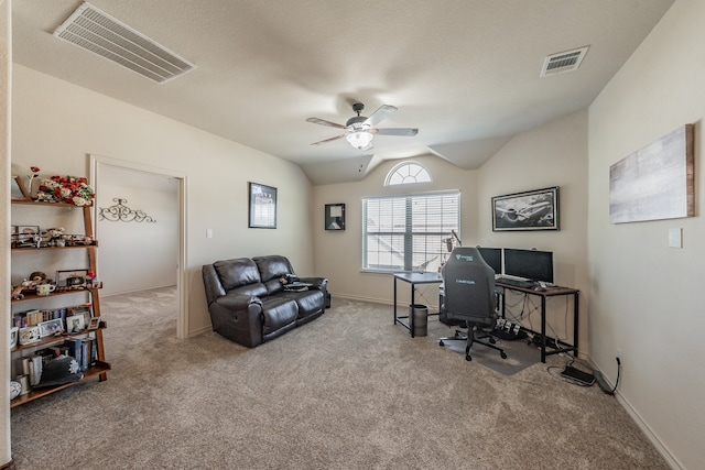 office area featuring vaulted ceiling, light carpet, and ceiling fan