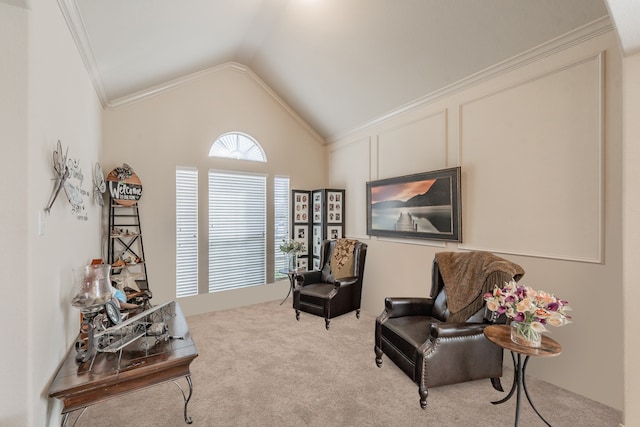 sitting room with light carpet, ornamental molding, and vaulted ceiling