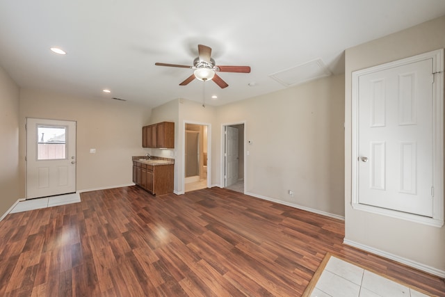 unfurnished living room featuring dark hardwood / wood-style floors and ceiling fan