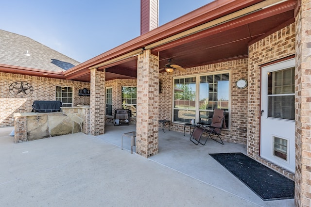 view of patio with an outdoor kitchen and ceiling fan