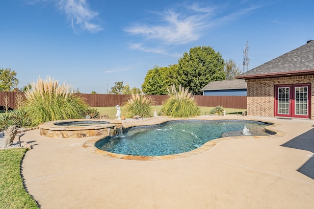 view of swimming pool with an in ground hot tub, a patio area, pool water feature, and french doors