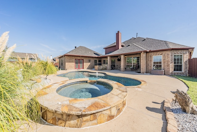 view of pool featuring an in ground hot tub and a patio