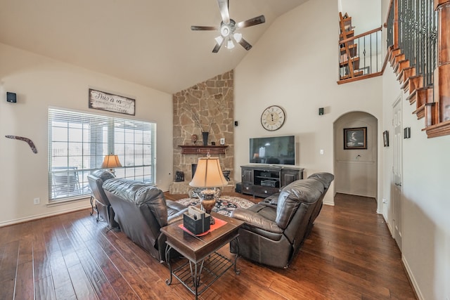 living room with dark hardwood / wood-style floors, high vaulted ceiling, a fireplace, and ceiling fan