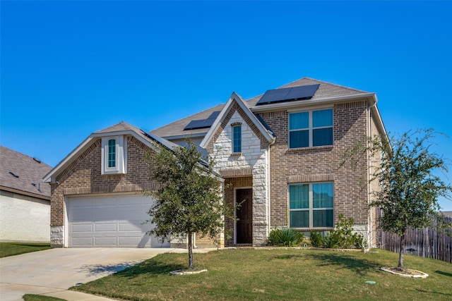 view of property with a front yard, a garage, and solar panels