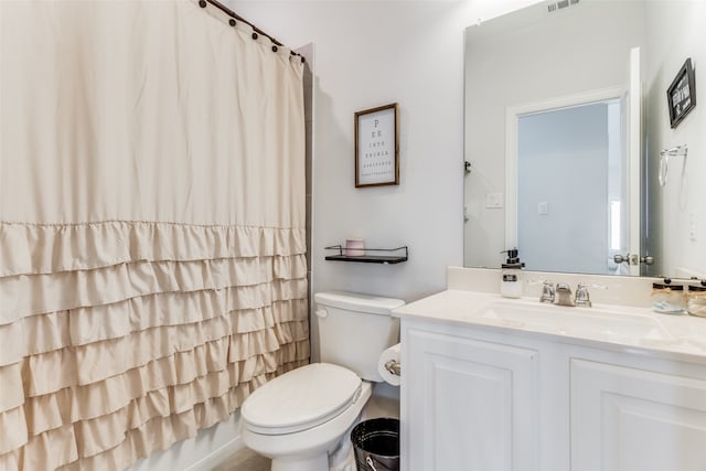 bathroom with vanity, toilet, and walk in shower