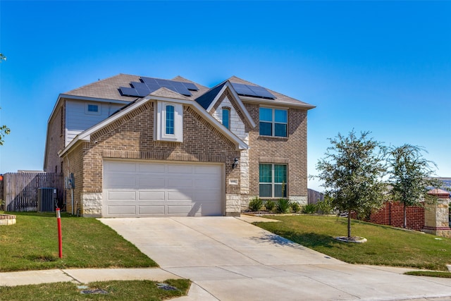 front of property featuring solar panels, a front lawn, and a garage