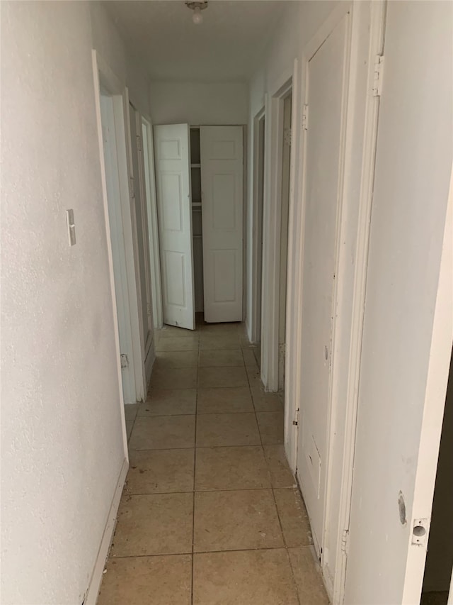 corridor featuring light tile patterned flooring