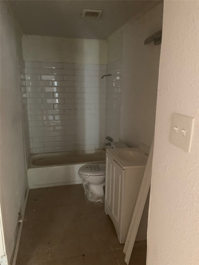 full bathroom with vanity, tiled shower / bath combo, toilet, and tile patterned flooring