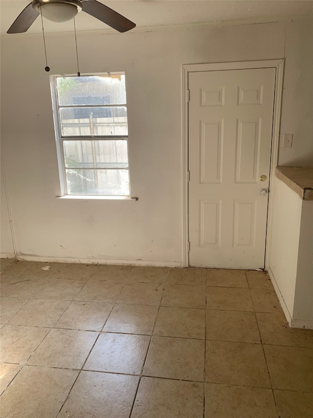 interior space featuring light tile patterned flooring and ceiling fan