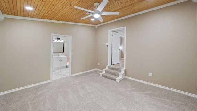 spare room featuring light carpet, ornamental molding, wooden ceiling, and ceiling fan