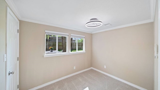 carpeted spare room with ornamental molding