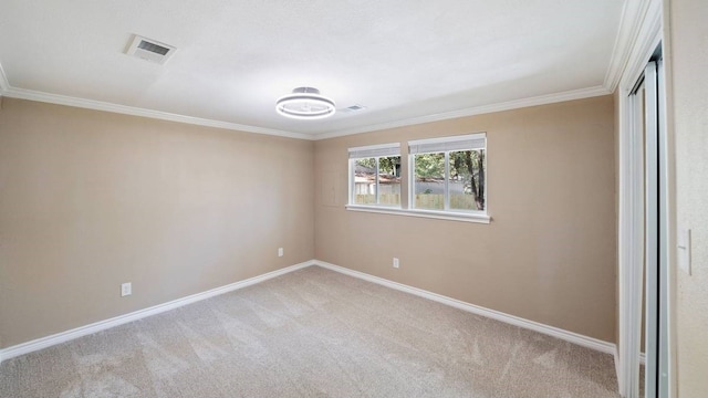 carpeted spare room with crown molding