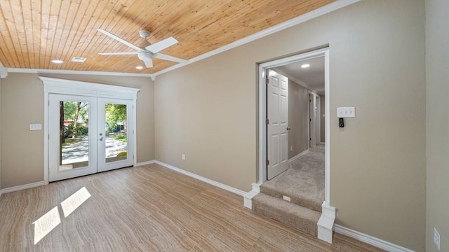 unfurnished room with wood ceiling, lofted ceiling, ceiling fan, crown molding, and french doors