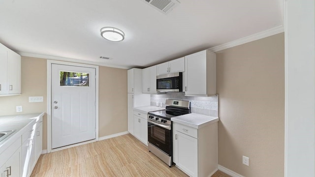 kitchen featuring appliances with stainless steel finishes, crown molding, white cabinets, and light hardwood / wood-style floors