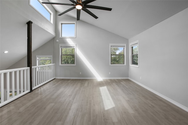 additional living space featuring ceiling fan, high vaulted ceiling, wood-type flooring, and a wealth of natural light