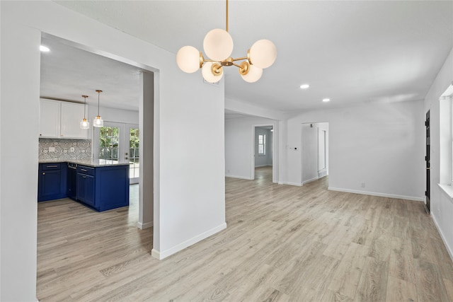 interior space with a chandelier and light hardwood / wood-style floors