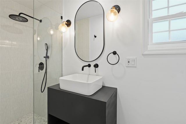 bathroom with vanity and a tile shower