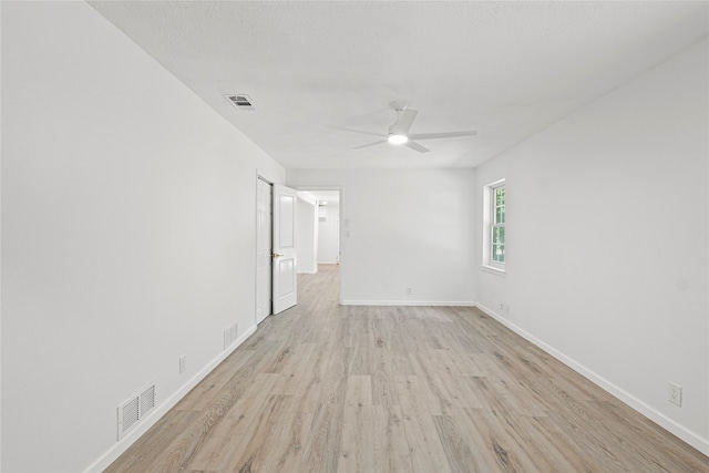 spare room with ceiling fan and light hardwood / wood-style flooring