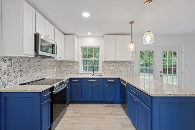 kitchen featuring blue cabinets, sink, hanging light fixtures, white cabinetry, and stainless steel appliances