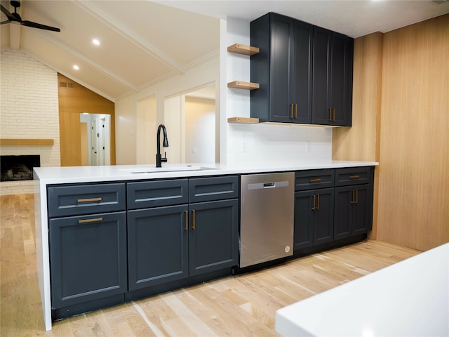 kitchen featuring ceiling fan, light wood-type flooring, vaulted ceiling with beams, dishwasher, and sink