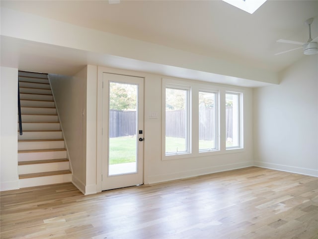 entryway featuring a skylight, light wood-type flooring, and ceiling fan