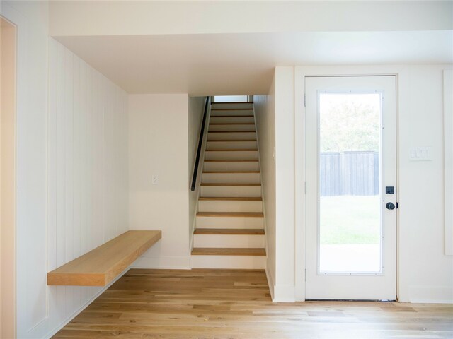 staircase featuring hardwood / wood-style flooring and a healthy amount of sunlight