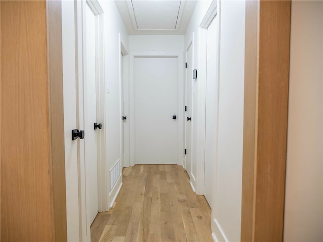 corridor with light wood-type flooring