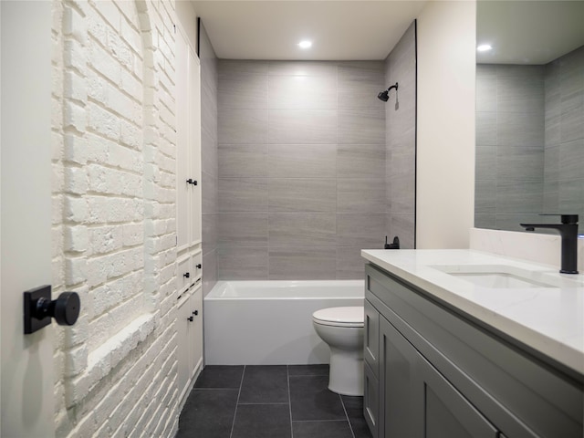 full bathroom with tiled shower / bath, vanity, toilet, and tile patterned flooring