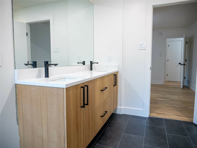 bathroom with vanity, ornamental molding, and hardwood / wood-style floors