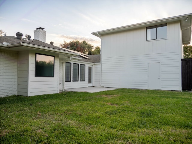 back of house with a yard and a patio area