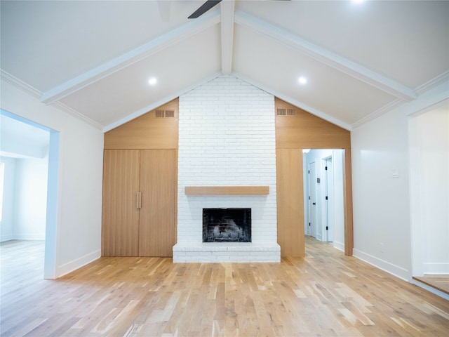 unfurnished living room with ornamental molding, lofted ceiling with beams, a fireplace, and wood-type flooring