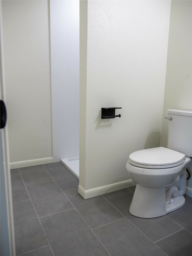 bathroom featuring toilet and tile patterned floors