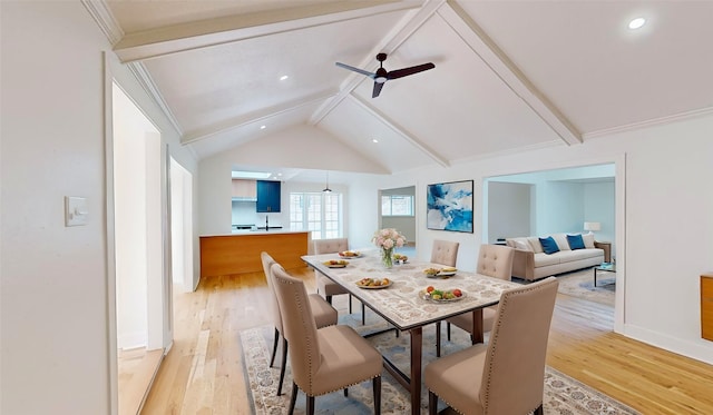 dining room with light hardwood / wood-style floors, lofted ceiling with beams, and ceiling fan