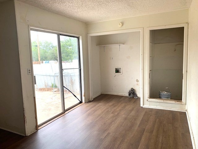 laundry area with a textured ceiling, washer hookup, and dark hardwood / wood-style flooring