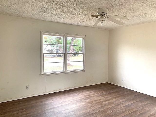 unfurnished room featuring a textured ceiling, dark hardwood / wood-style floors, and ceiling fan