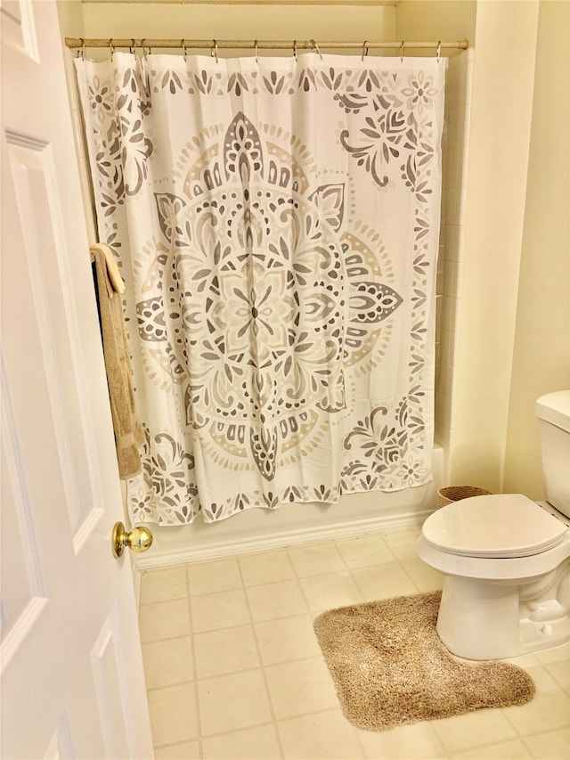 bathroom with toilet, shower / bathtub combination with curtain, and tile patterned floors