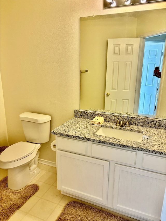 bathroom with vanity, toilet, and tile patterned flooring